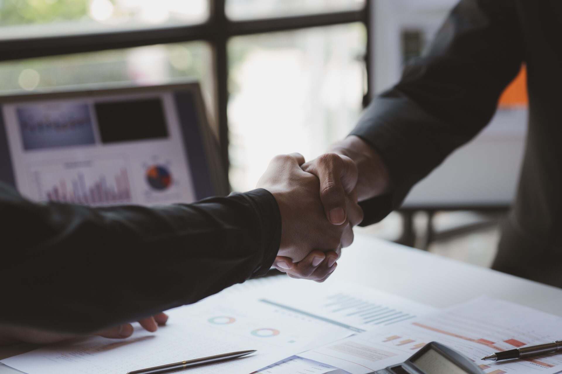 Business investor group holding hands, Two businessmen are agree Business investor group holding hands, Two businessmen are agreeing on business together and shaking hands after a successful negotiation. Handshaking is a Western greeting or congratulation.